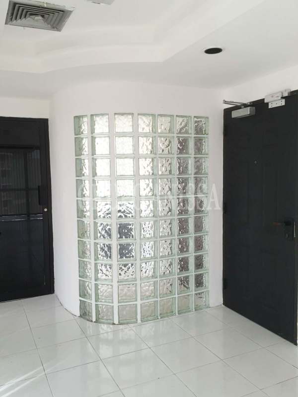 Bright modern hallway with floor-to-ceiling windows, vertical blinds, glass block wall in PH BAC Tower