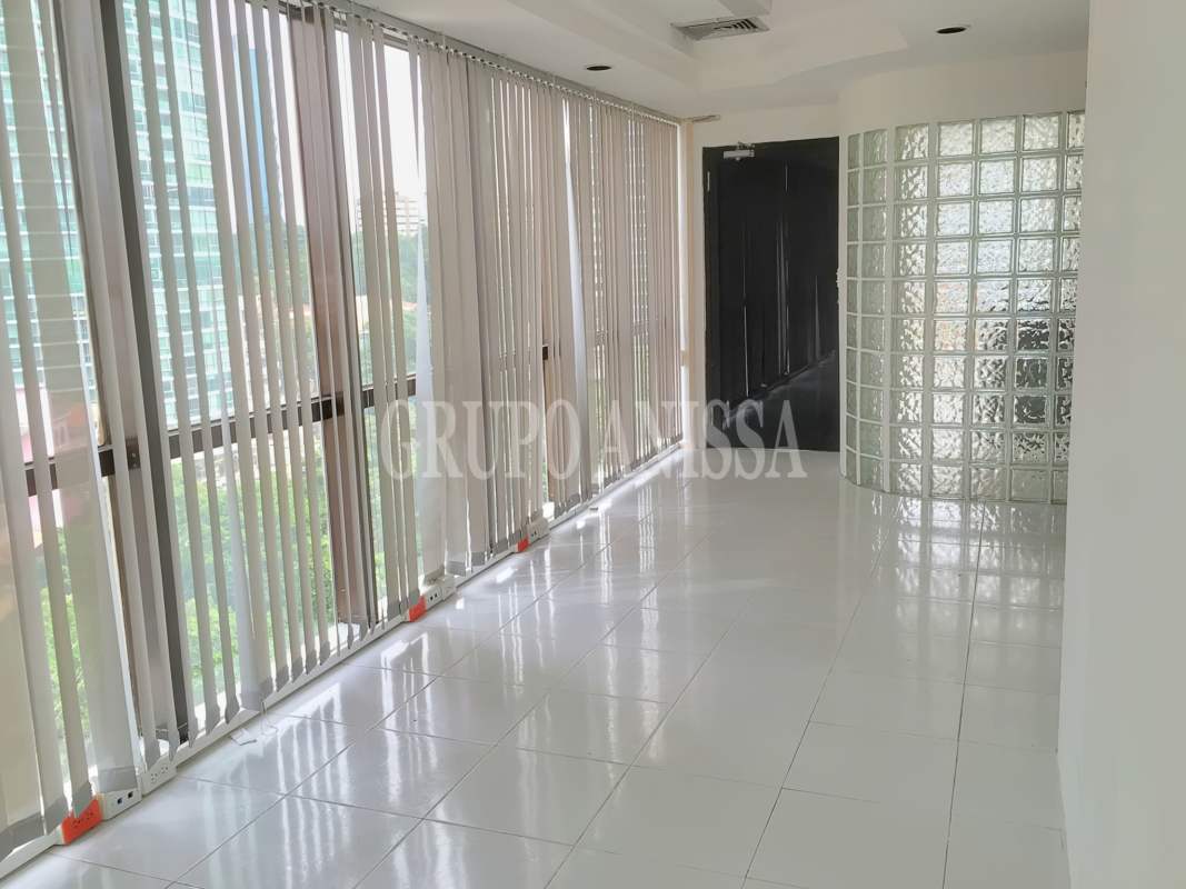 Modern entry foyer and entryway inside PH BAC Tower office space with glass block wall and tile floor