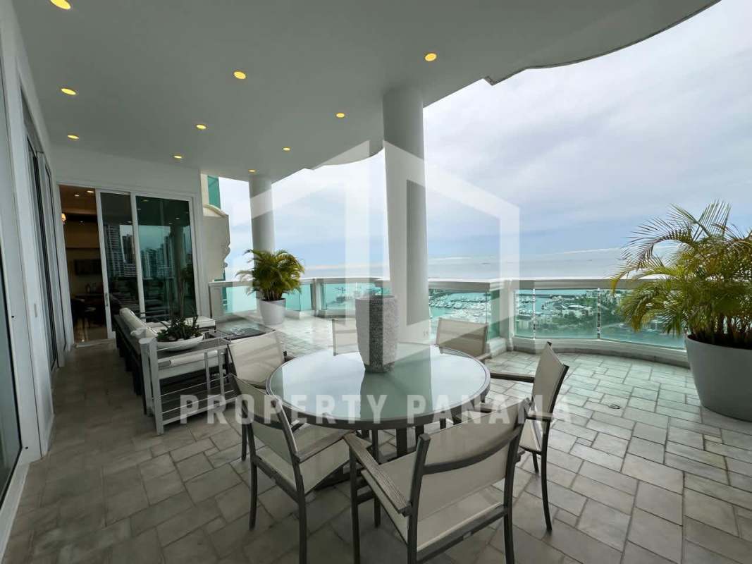 Spacious waterfront balcony with dining table, seating, panoramic Pacific view at PH Bellagio Punta Pacífica