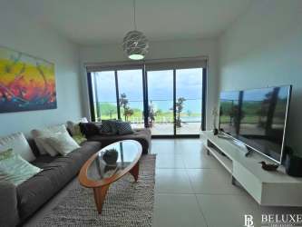 Open-concept living area with ocean views and natural light in Punta Caelo beachfront condo Panama