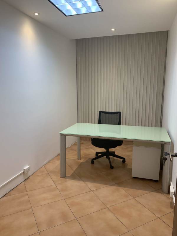 Minimalist office with glass-top desk vertical blinds tiled floor in PH Omega Obarrio Panama