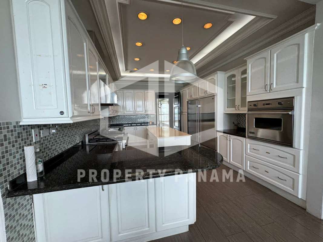 Modern kitchen with granite counters center island stainless appliances at PH Peninsula Panama