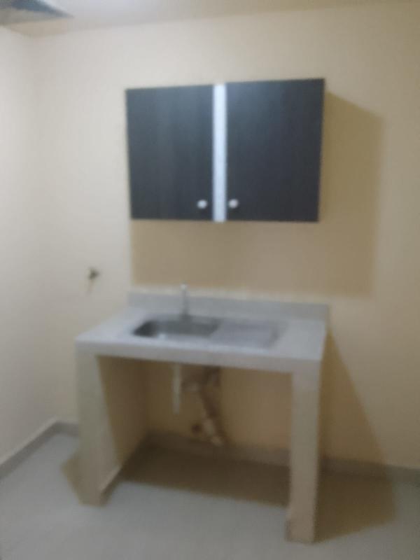 Simple white toilet inside bathroom budget apartment Rio Abajo Panama