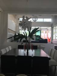 Modern living room with large glass windows, sofa, garden view Santa Clara luxury property