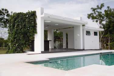 Terrace with orange cushions, hammock garden view luxury estate Santa Clara Panama