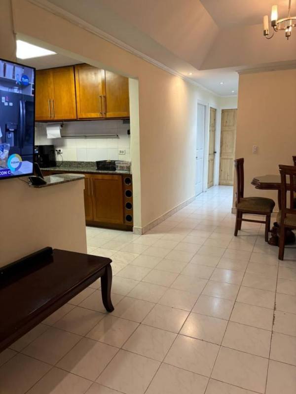 Kitchen with wood cabinets, granite countertops, tile backsplash in house Brisas del Golf Panama City