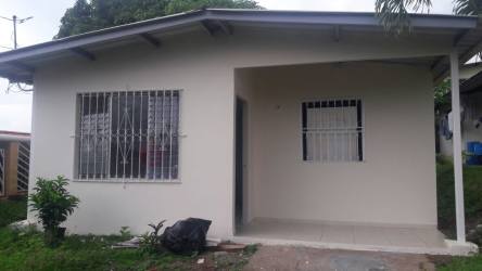 Compact kitchenette with wooden upper and lower cabinets, tile backsplash La Chorrera Panama