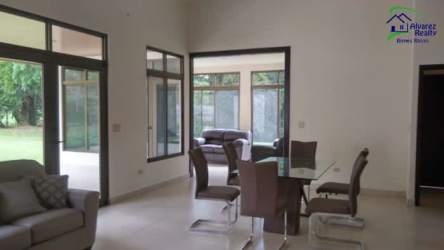 Spacious modern open-plan living and dining with large windows and mountain views at Volcán