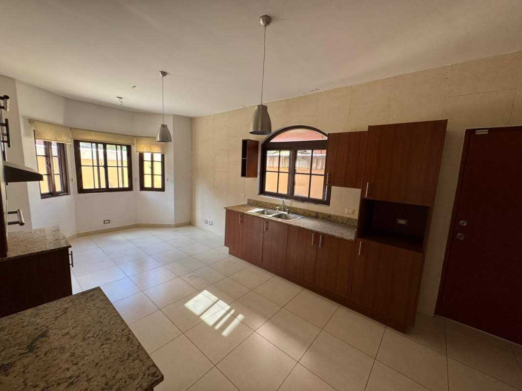 Covered terrace with columns and fans in Costa Sur house Panama