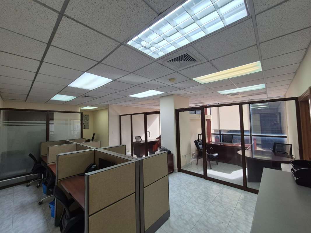 Open space with cubicles glass partitions modern commercial office Plaza Banco General Panama City