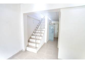 Minimalist kitchen ceramic tile countertops bright wall window Panama countryside home