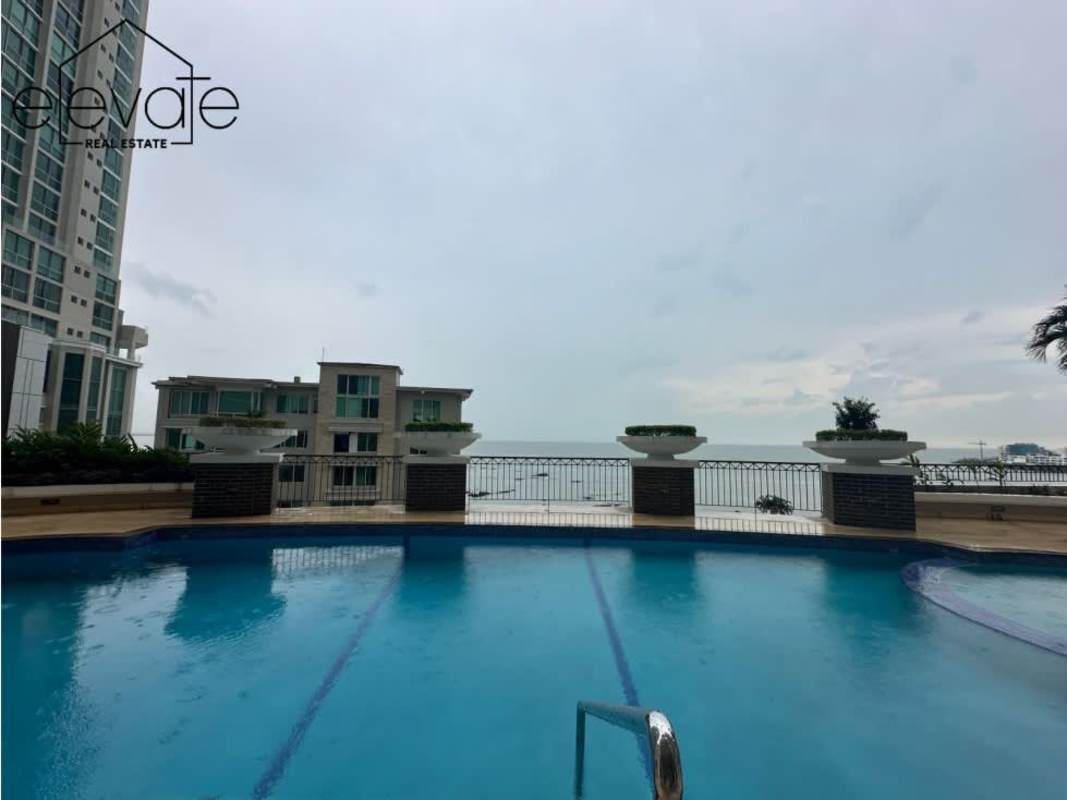 Open living dining room marble floors floor-to-ceiling windows ocean views in PH Pacific Point Punta Pacifica