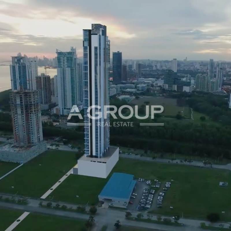 Aerial view of Arcadia Tower in Costa del Este surrounded by city skyline, waterfront and parks Panama City