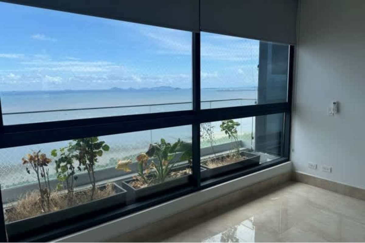 Bright interior space with large windows, ocean view, planters at PH Mirador Costa del Este Panama