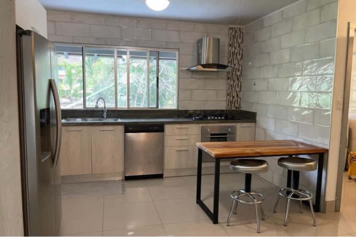 Large bedroom with natural light and garden views in Clayton house Panama City