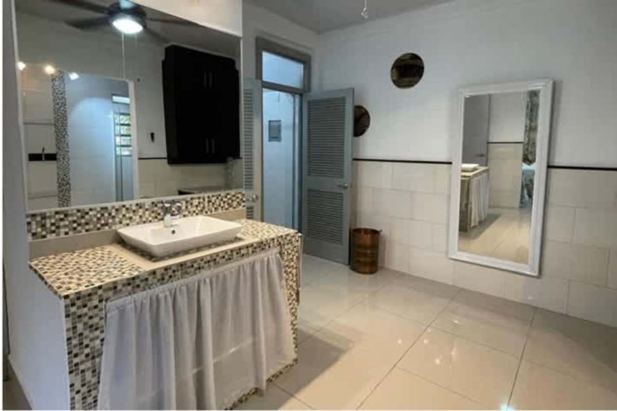 Spacious terrace with outdoor seating and garden view in Clayton Panama home