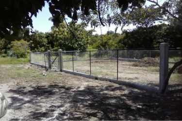 Chain-link fenced lot with entrance gate in Nueva Gorgona, ready to build near Playa Gorgona.
