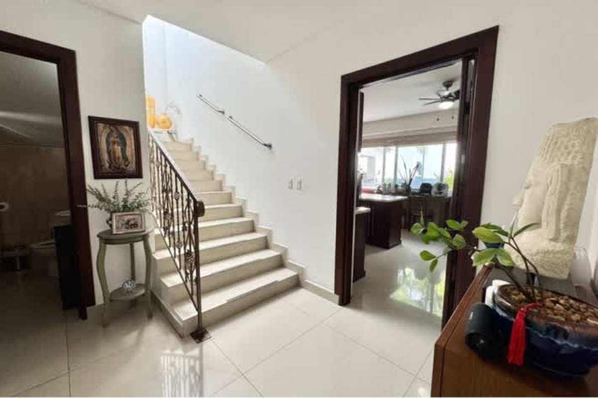 Spacious entrance hall with elegant staircase in luxury house Altos del Golf Panama City