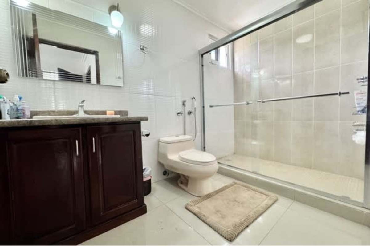 Spacious bedroom with accent wall, bunk bed, modern furniture in Altos del Golf luxury house Panama