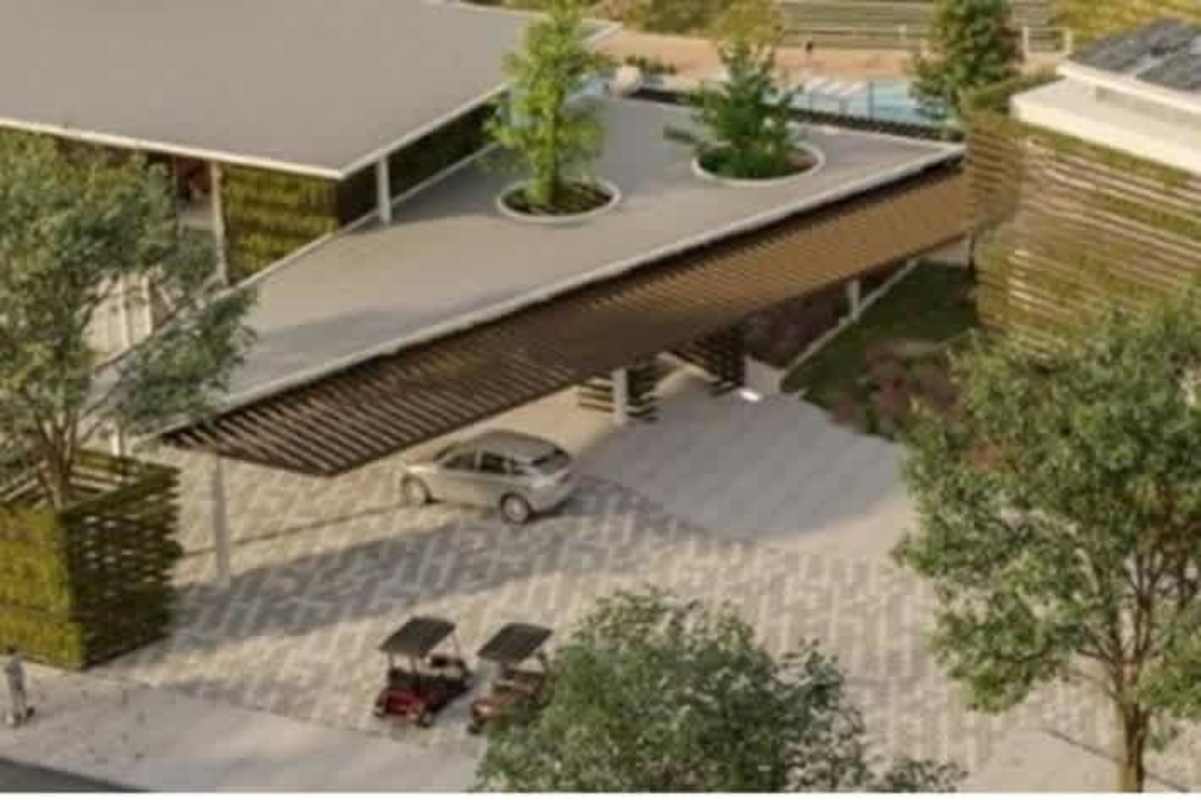 Modern commercial complex with canopy, rooftop planters, solar panels and parking at Green City Panama