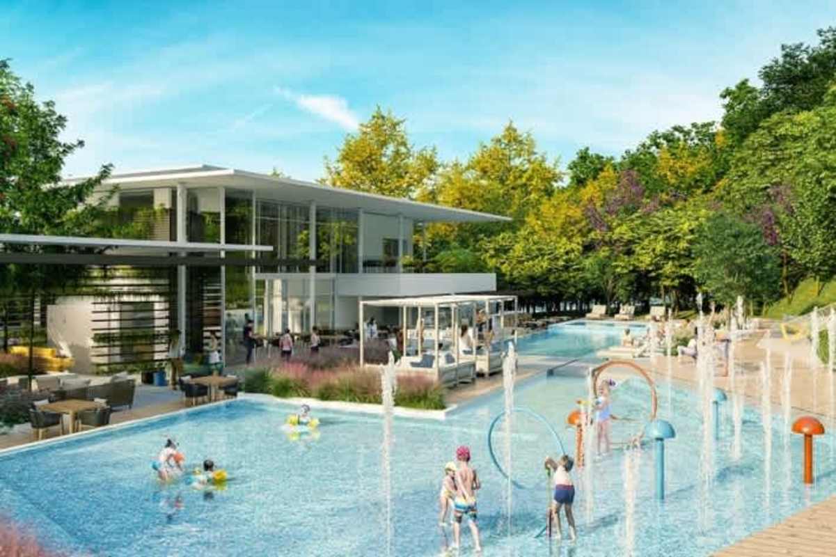 Residential clubhouse with swimming pool, kids water play area surrounded by landscaping in Green City Panama