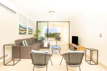 Bright living room with large windows ocean views in Perlamar Tower Casamar Panama