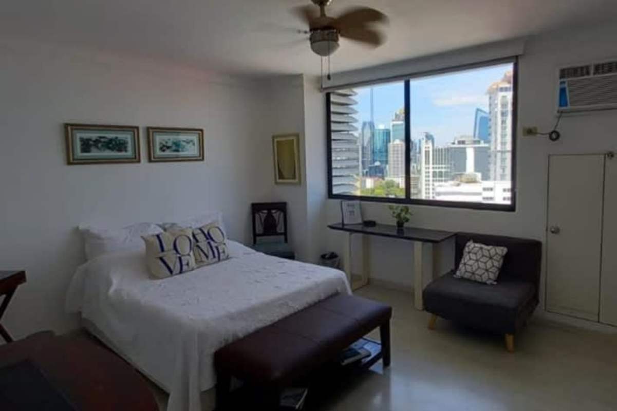 Spacious bedroom with large windows, minimal decor and skyline views in El Cangrejo Tower Panama