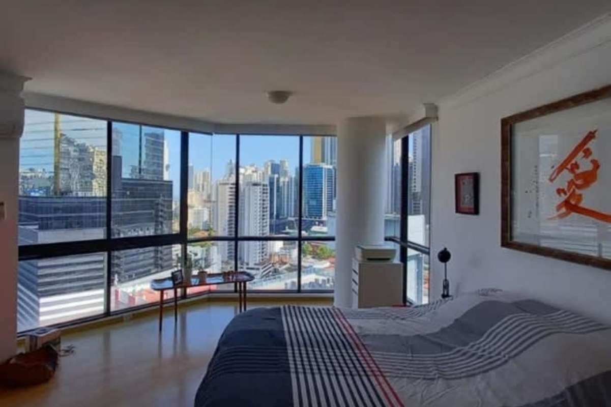 Modern bedroom with floor-to-ceiling windows city skyline PH El Cangrejo Tower Panama City
