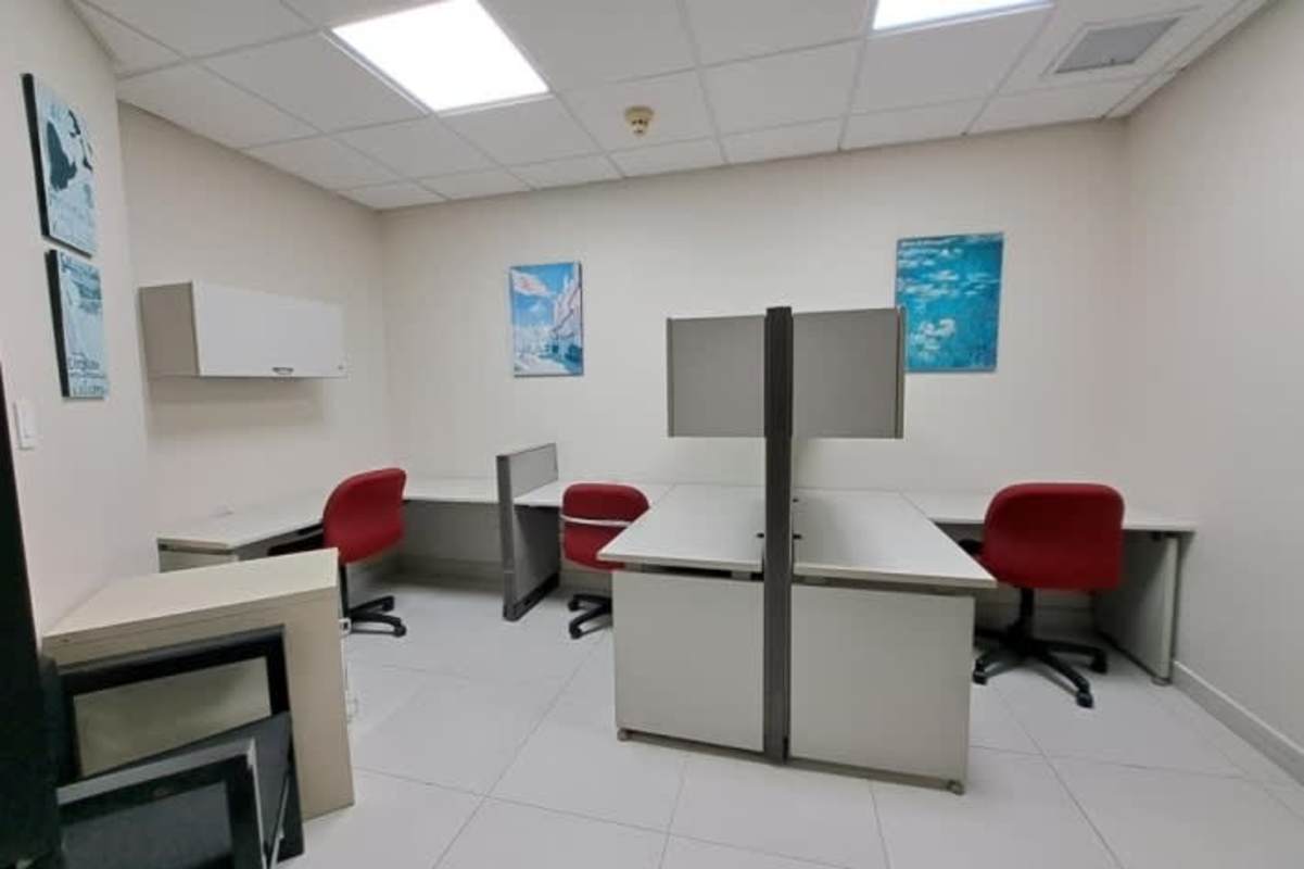 Shared open cubicle workspace with ergonomic chairs in PH Banco General Tower Panama City