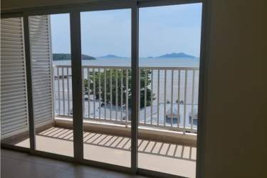 Living room opening to balcony with Pacific Ocean views in Playa Dorada condo Panama