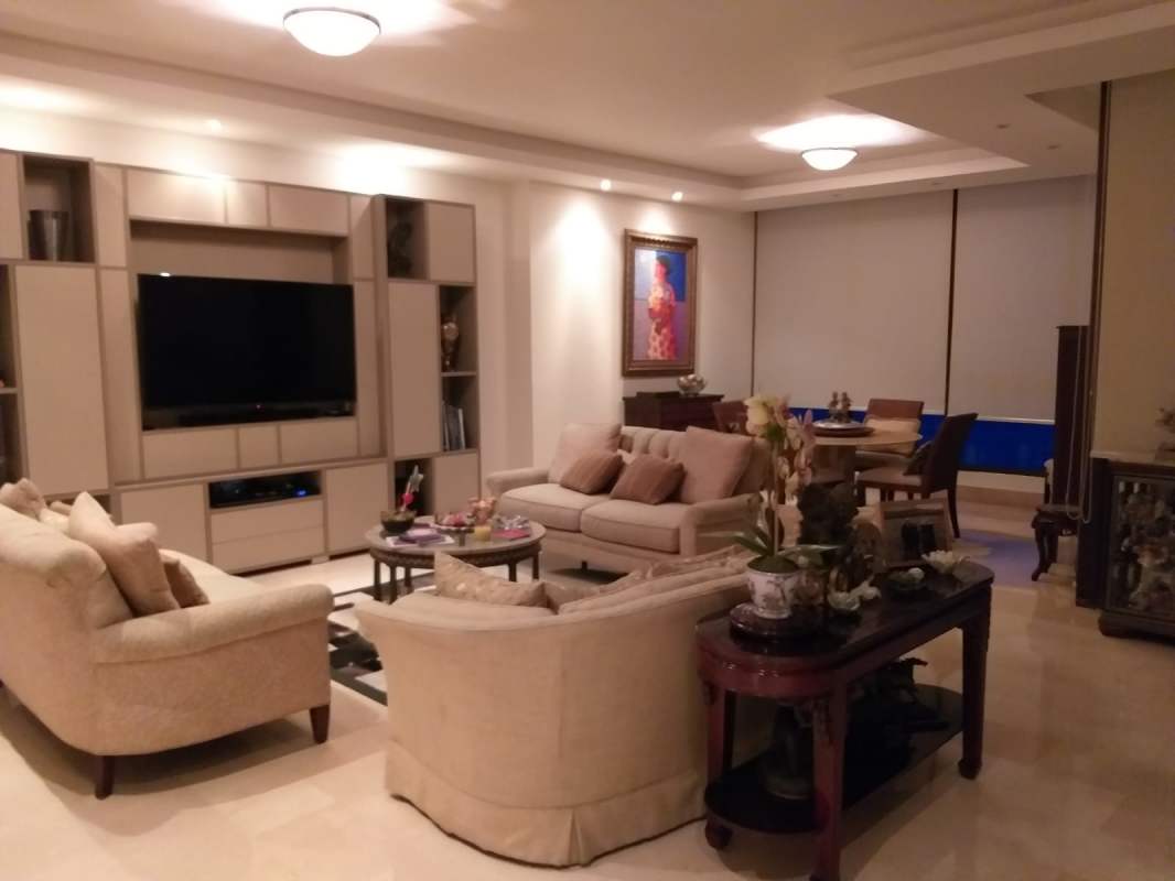 Modern living and dining space with beige furniture, entertainment center, wall art and large windows PH Regalia Costa del Este