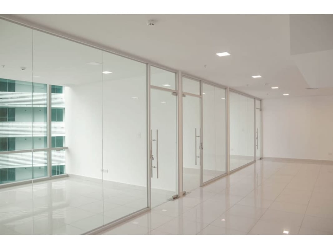 Private meeting rooms with glass partitions and tiled floors in luxury tower Costa del Este