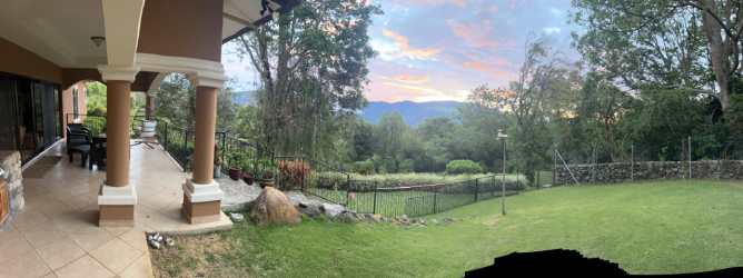Traditional kitchen with granite countertops and hardwood cabinetry in Volcansito Boquete luxury house