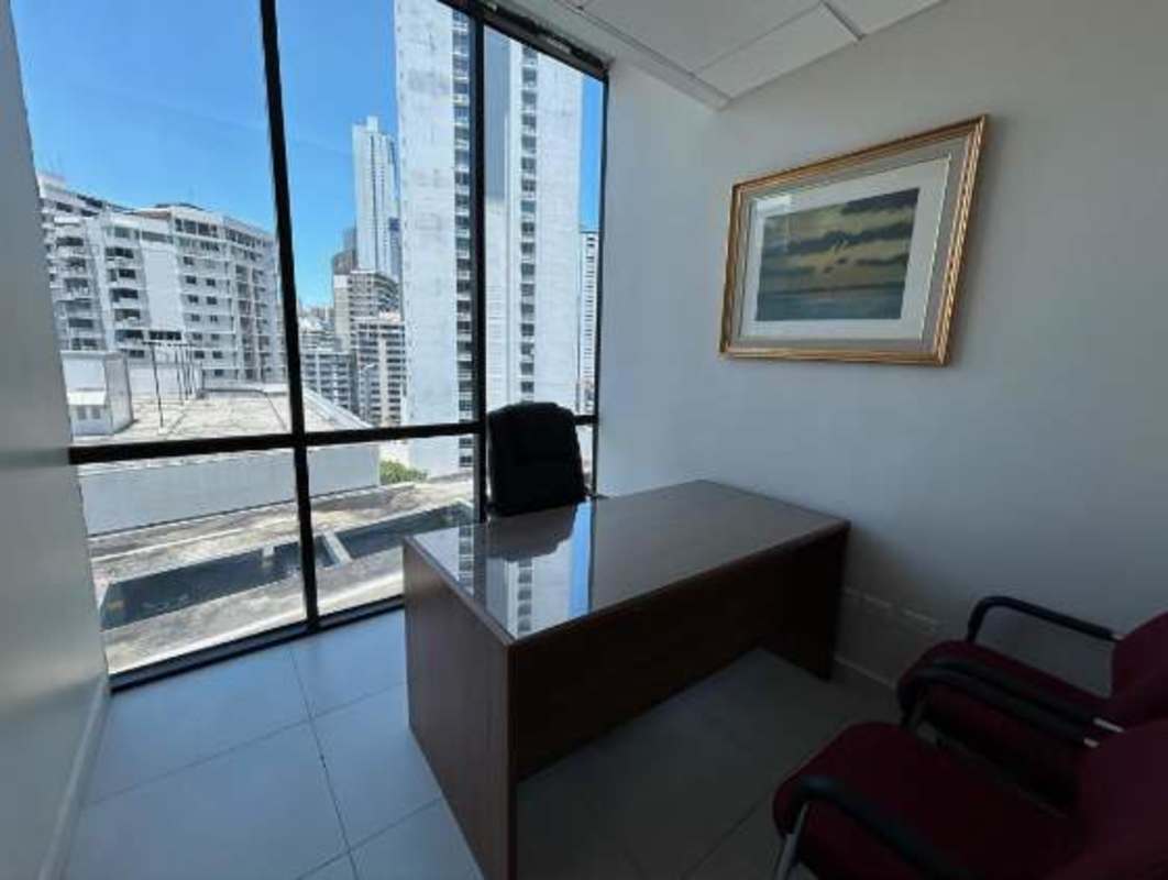 Private office with large windows, city skyline view, wood desk Banco General Tower Panama