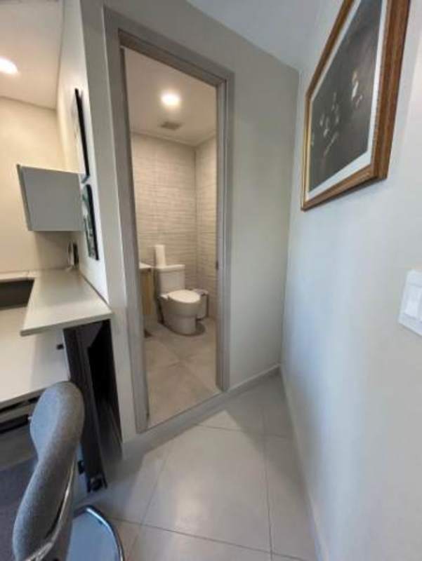 Small fully tiled bathroom attached to office in Torre Banco General Panama City