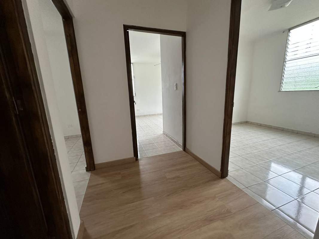 Apartment hallway connecting rooms with windows, tile and wood flooring PH Las Roccas Panama