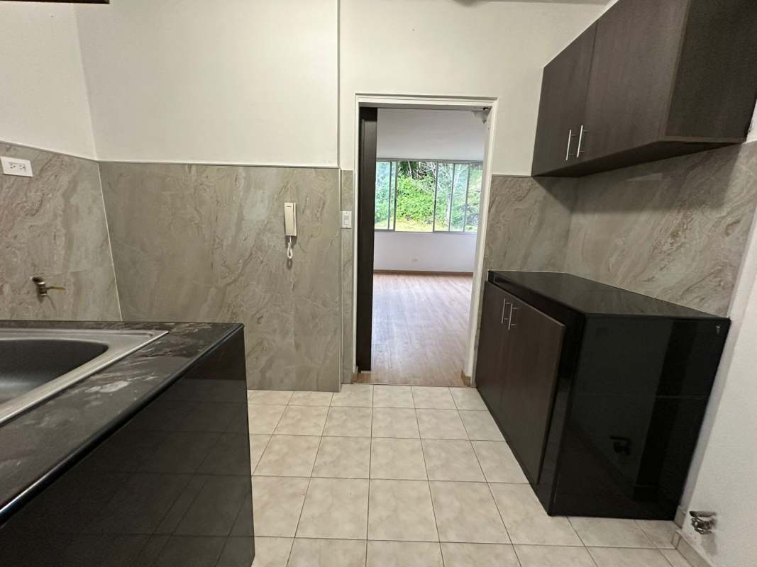 Contemporary kitchen with dark cabinets, stone backsplash PH Las Roccas for sale