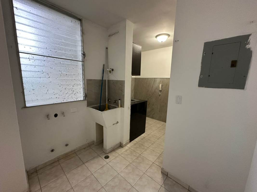 Laundry area with utility sink, frosted window, hookups PH Las Roccas apartment Panama