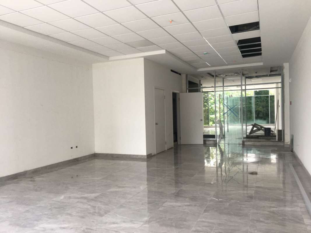 Bright hallway with glass partitions polished floors in Sunset Strip office tower Panama