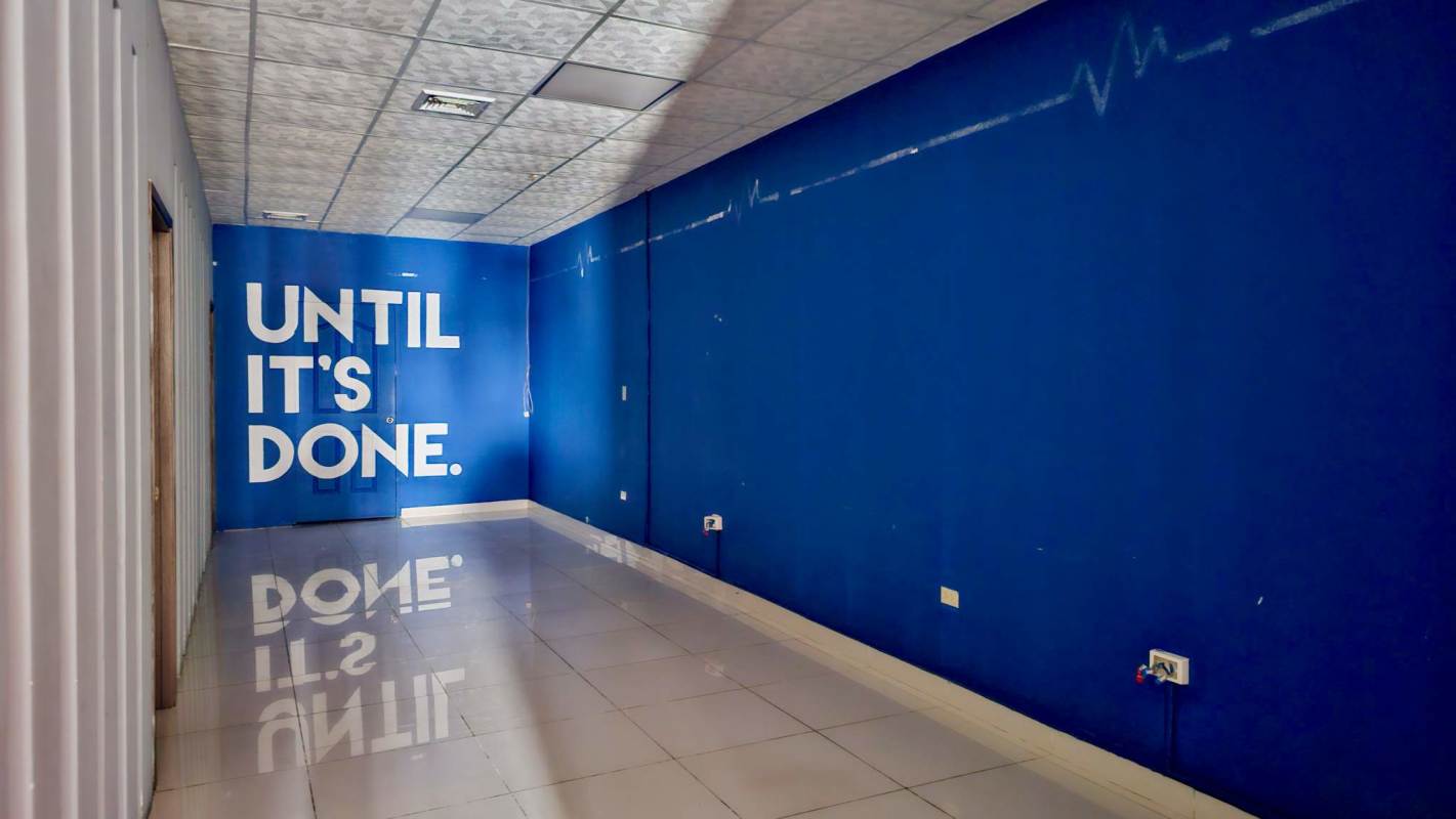 Office hallway with blue motivational wall and tiled floors in Display Plaza Panama