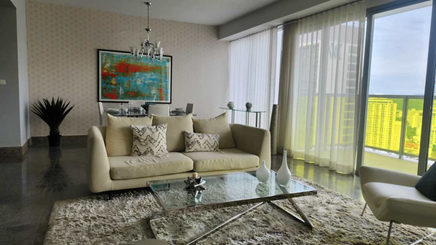 Modern open-plan living and dining with city skyline view, floor-to-ceiling windows in Yoo Panama