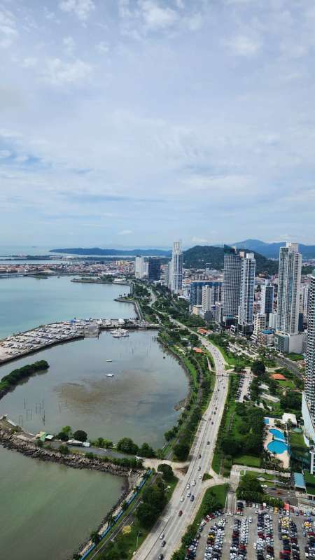Infinity pool with sun deck overlooking Pacific Ocean at Yoo Panama tower Avenida Balboa