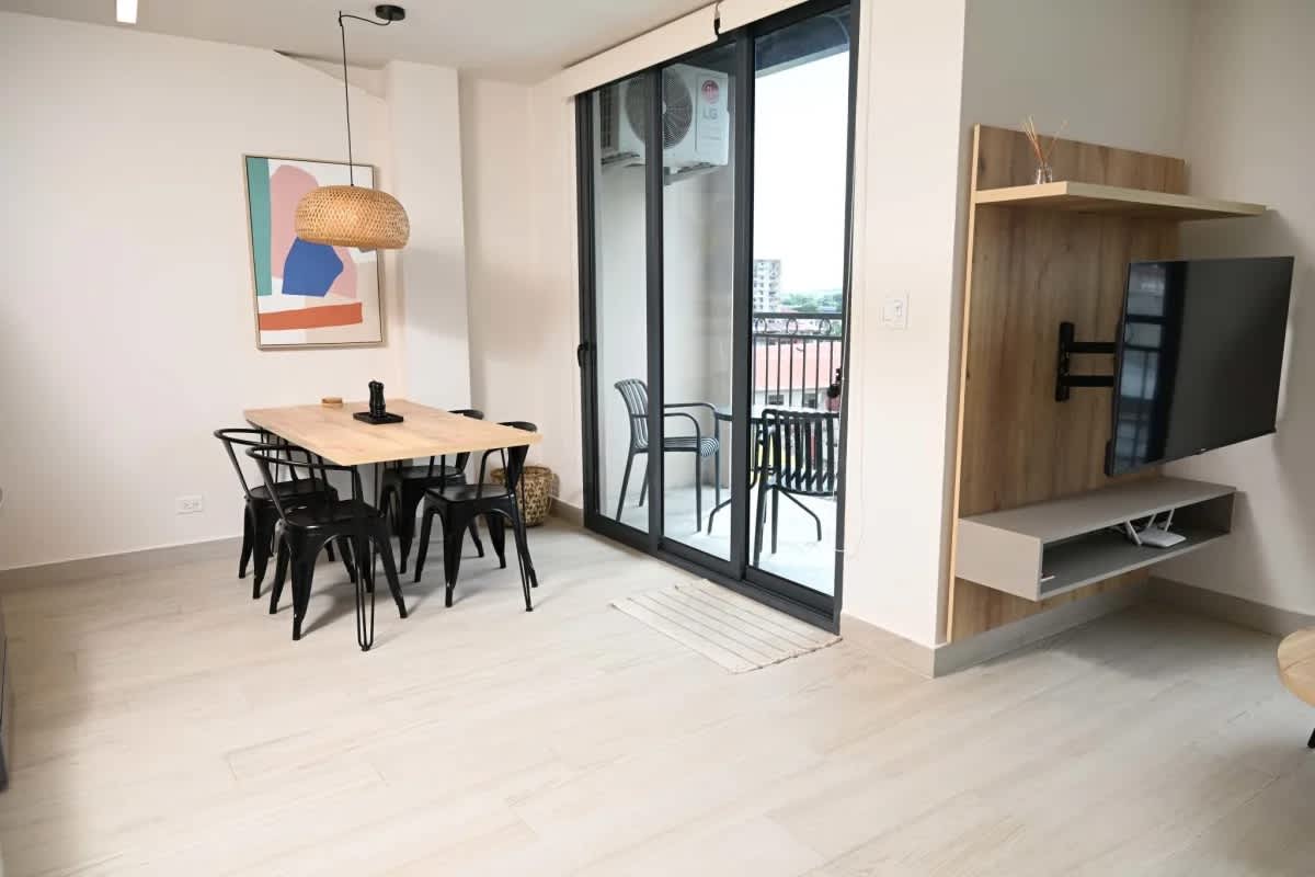 Modern minimalist kitchen with stainless steel appliances, dining area at Casco View Residences Santa Ana Panama