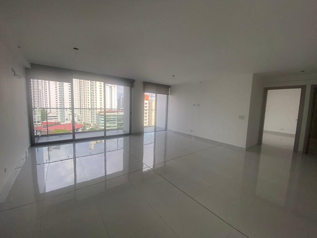 Spacious living room with large windows overlooking Panama City skyline in PH Velure