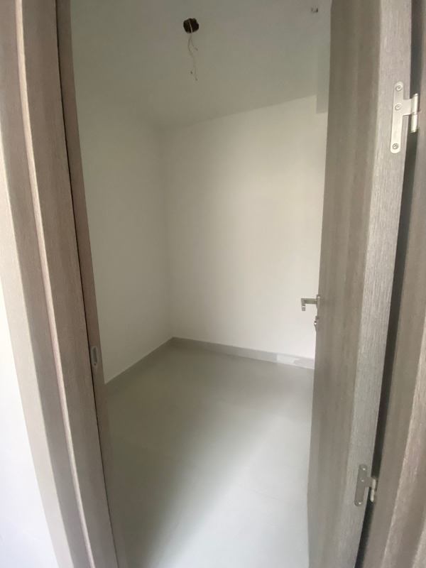 Modern minimalist galley kitchen with oven, stove, cabinetry at PH Velure El Cangrejo Panama