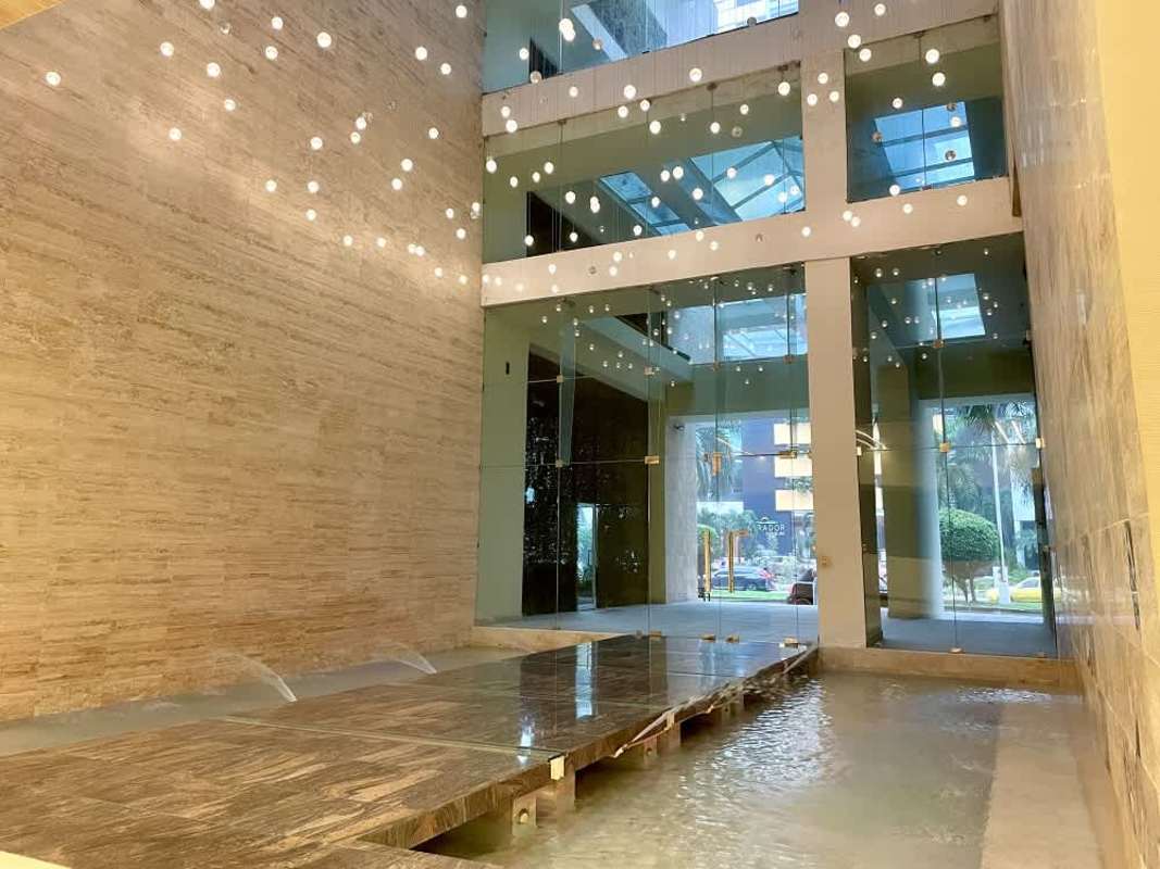 Stylish lobby entrance with water feature, glass walls in PH Santa Maria Court Costa del Este Panama