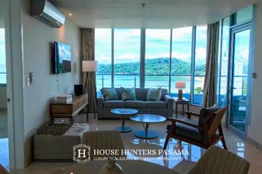 Modern living room with panoramic ocean views, large windows, natural light, and elegant furnishings in PH Casa Bonita Panama