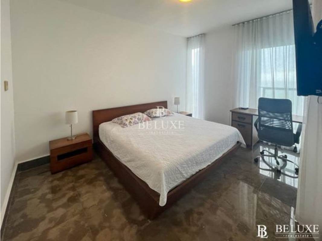 Minimalist bedroom with marble floors, blue bedding, large windows at PH Yoo