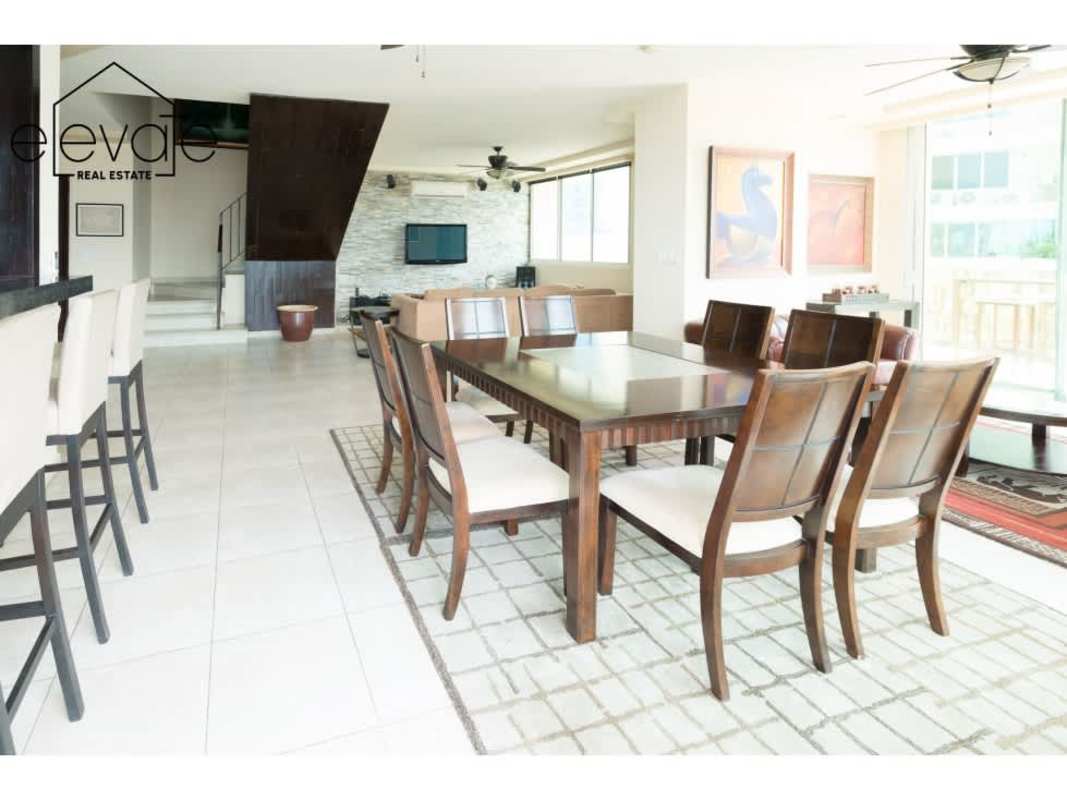 Dining area with floor-to-ceiling window overlooking Bay in Mystic Point