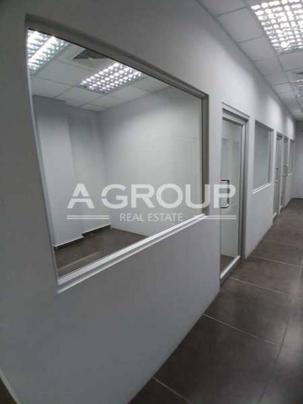 Hallway with glass entrance doors inside Edificio ELMEC commercial tower Panama City